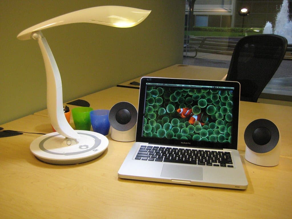 A magnifying clamp lamp with a glass lens
