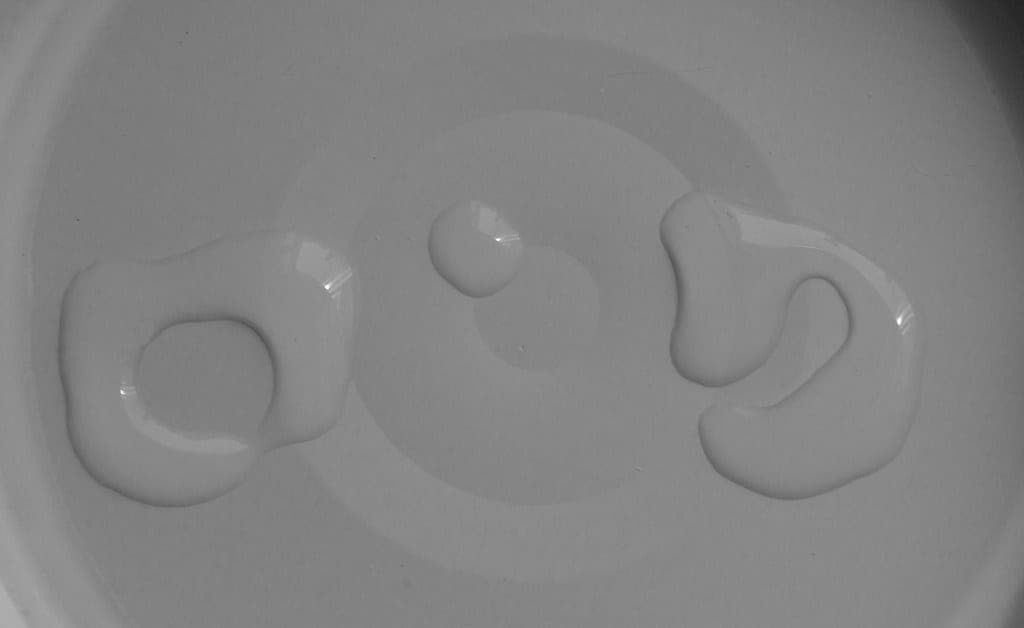 A brush being cleaned in soap