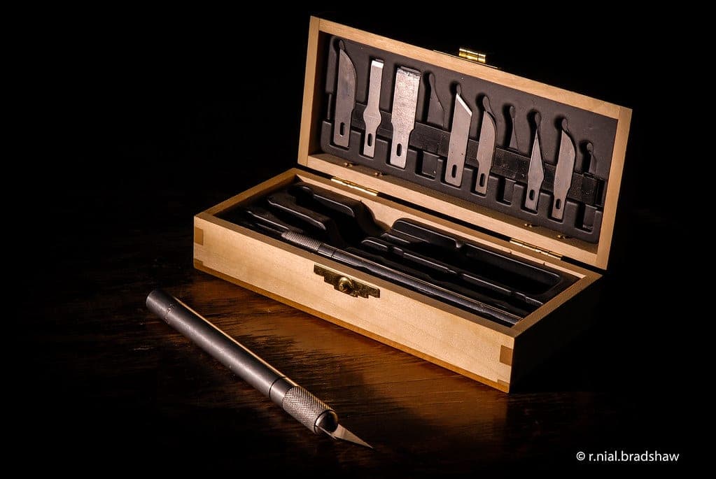 Hobby knife, nippers and sanding sticks arranged on a mat