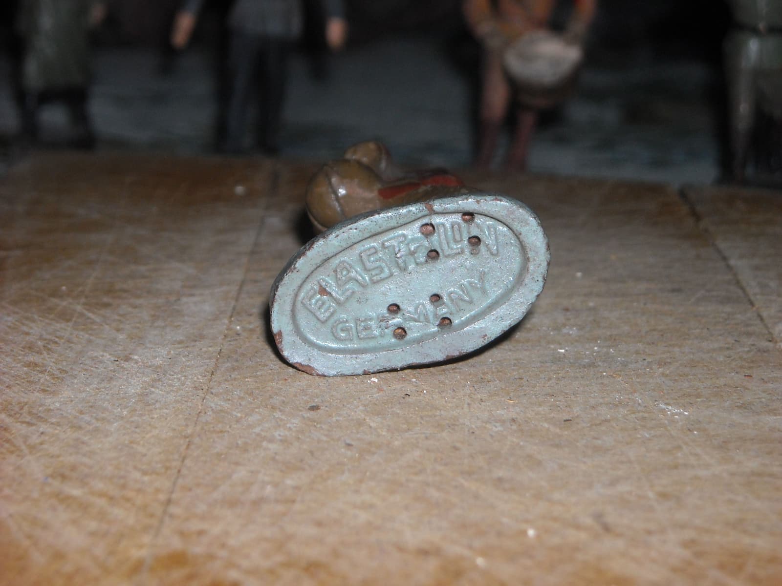 A part-painted miniature beside a brush and palette