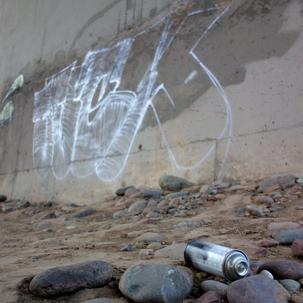 An aerosol primer can being used outdoors